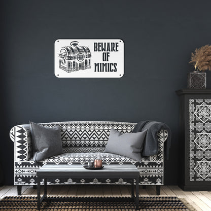 "Beware of Mimics" metal sign with a treasure chest graphic, playfully warning of hidden dangers. Ideal for TTRPG and gaming decor, made of 18-gauge steel and available in black, red, white, copper, or silver. Comes in six sizes ranging from 12 to 36 inches.